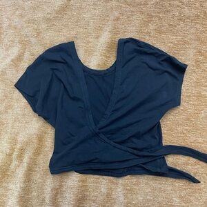 Lululemon short sleeve, waist length, tie thru yoga/dance top. Approx. size sm.